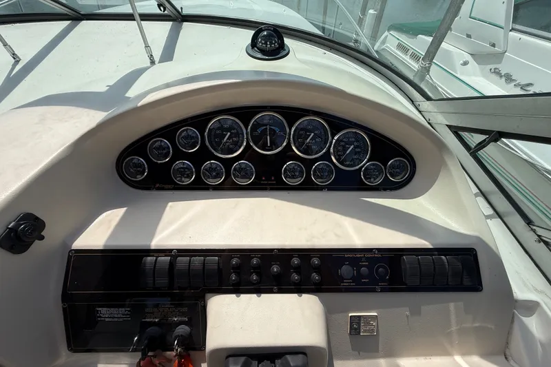Slide: The Image of 1999 Cruisers Yachts 3075 Rogue dashboard with gauges and controls. - 23