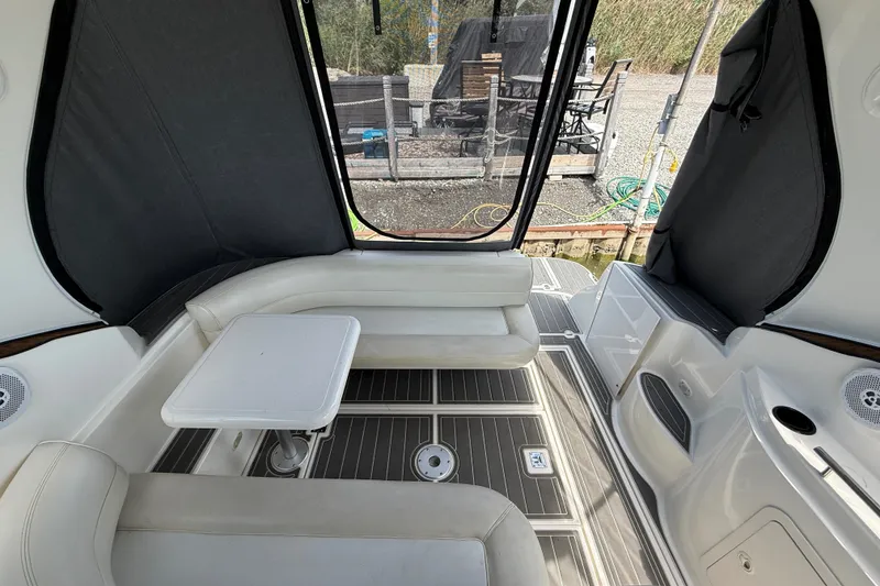 Slide: The Image of 1999 Cruisers Yachts 3075 Rogue interior with seating and table, dockside view. - 11