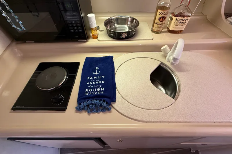 Slide: The Image of 1999 Cruisers Yachts 3075 Rogue kitchen with stove, sink, and decorative towel. - 36