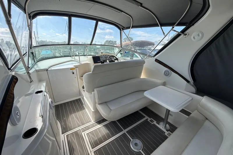 Slide: The Image of 1999 Cruisers Yachts 3075 Rogue interior with seating and helm, featuring modern design. - 7