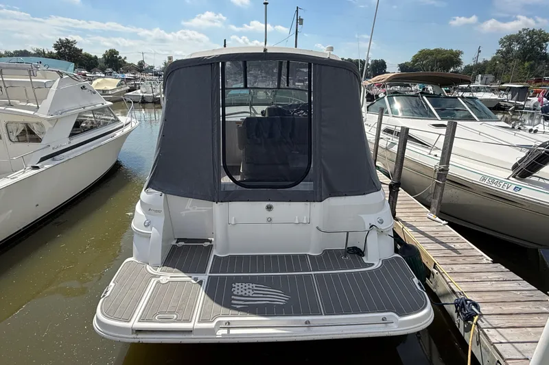 Slide: The Image of 1999 Cruisers Yachts 3075 Rogue docked at marina, rear view with canopy. - 1