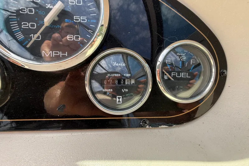 Slide: The Image of Dashboard gauges of a 1999 Cruisers Yachts 3075 Rogue, showing speed, hours, and fuel levels. - 25