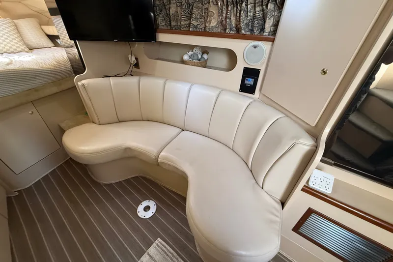 Slide: The Image of 1999 Cruisers Yachts 3075 Rogue interior with curved leather seating and modern amenities. - 30