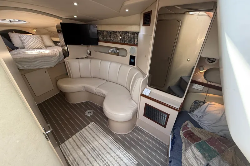 Slide: The Image of 1999 Cruisers Yachts 3075 Rogue interior with cozy seating and sleeping area. - 27