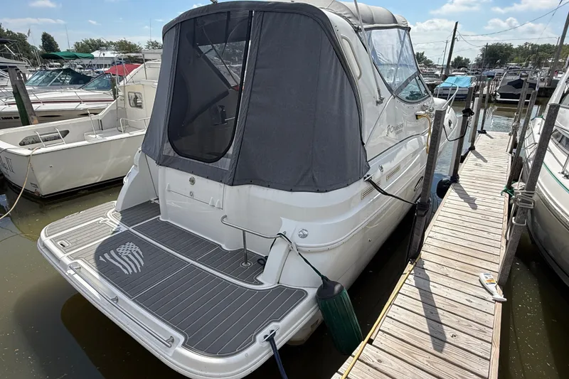 Slide: The Image of 1999 Cruisers Yachts 3075 Rogue docked at marina, rear view with canopy. - 5