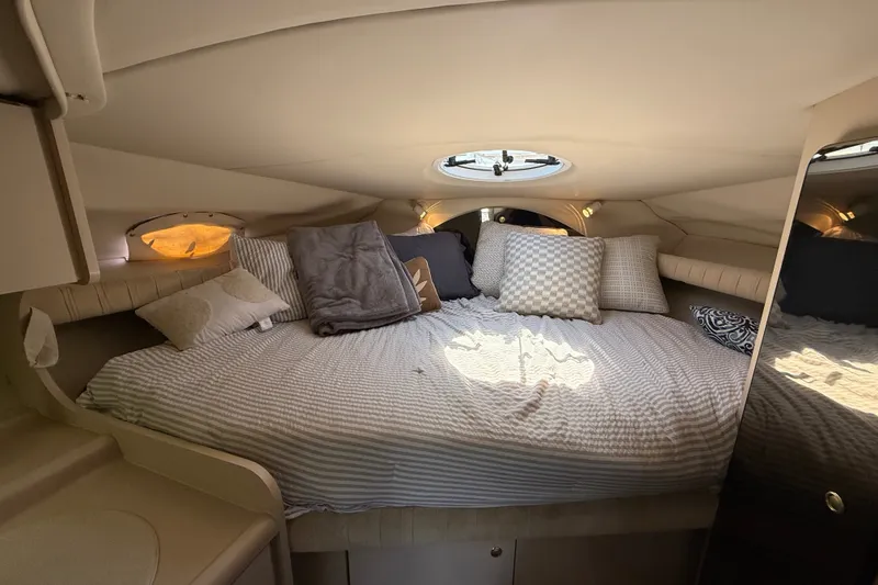 Slide: The Image of Cozy cabin interior of 1999 Cruisers Yachts 3075 Rogue with plush bedding and pillows. - 42