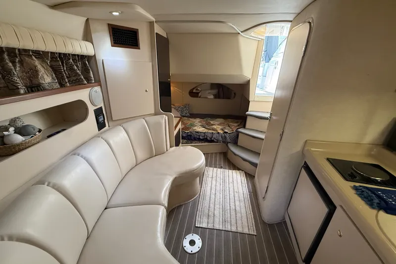 Slide: The Image of Interior of 1999 Cruisers Yachts 3075 Rogue with cozy seating and compact kitchen. - 44