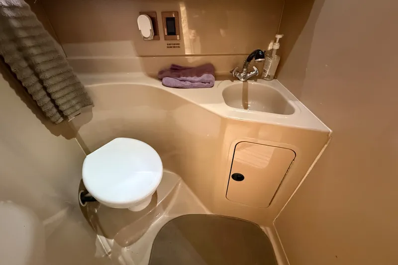 Slide: The Image of 1999 Cruisers Yachts 3075 Rogue bathroom with sink, toilet, and towel. - 48