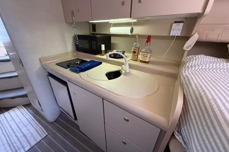 Slide: The Image of 1999 Cruisers Yachts 3075 Rogue interior kitchen with sink, microwave, and countertop. - 41