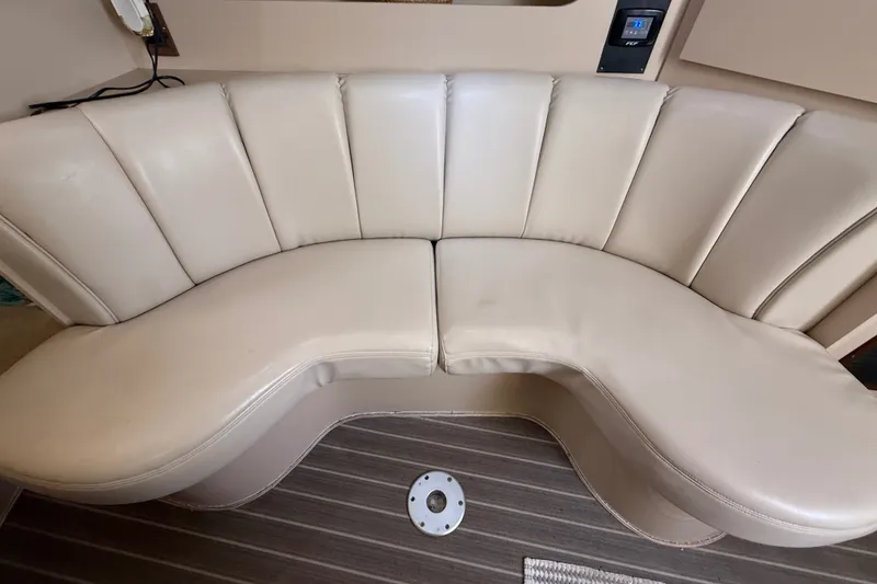 Slide: The Image of 1999 Cruisers Yachts 3075 Rogue interior with curved beige leather seating. - 32