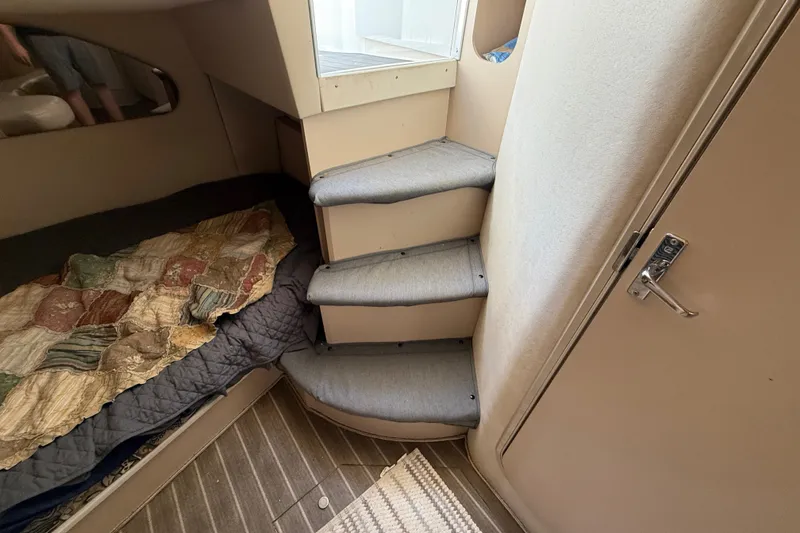 Slide: The Image of Interior of 1999 Cruisers Yachts 3075 Rogue with stairs and cozy sleeping area. - 54