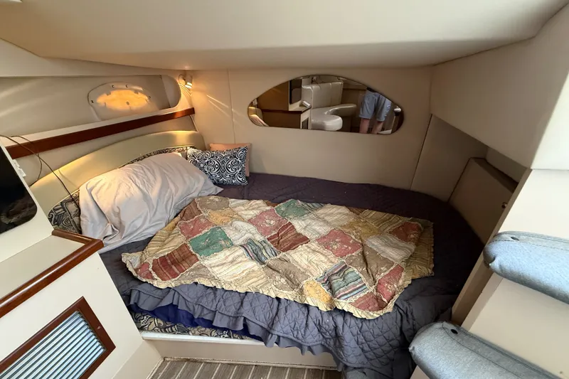 Slide: The Image of 1999 Cruisers Yachts 3075 Rogue cabin interior with cozy bed and quilt. - 45