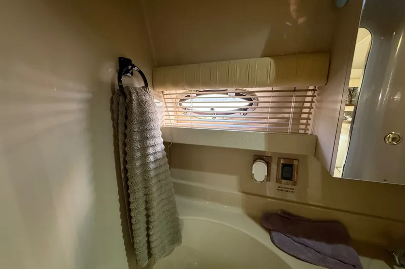 Slide: The Image of 1999 Cruisers Yachts 3075 Rogue bathroom with towel, window, and controls. - 50