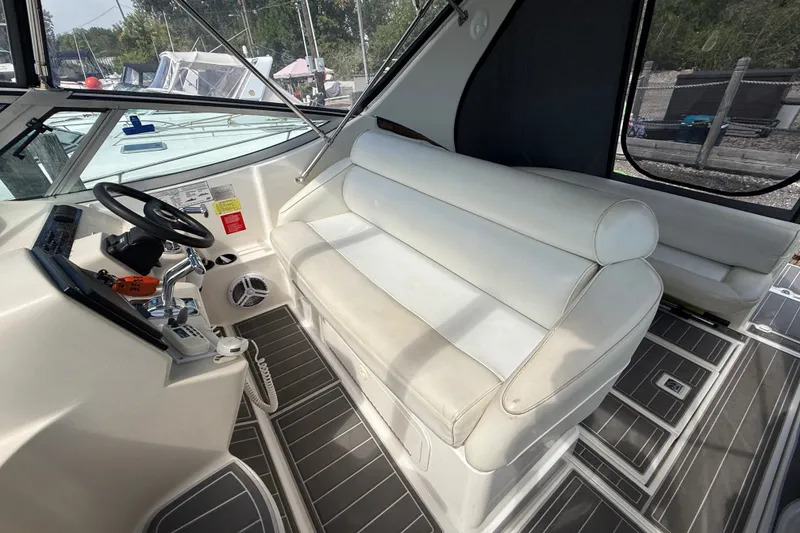 Slide: The Image of 1999 Cruisers Yachts 3075 Rogue interior with helm and seating area. - 16