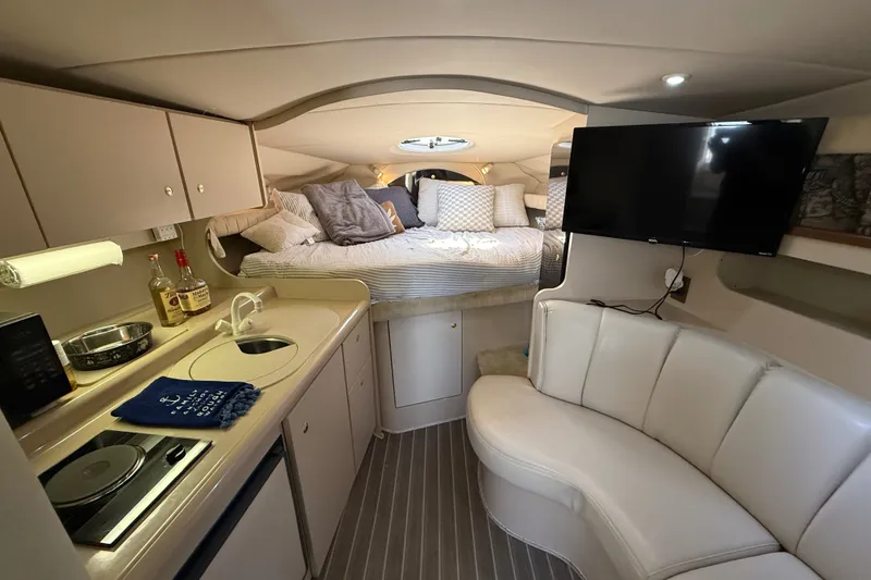 Slide: The Image of Luxurious interior of 1999 Cruisers Yachts 3075 Rogue with kitchenette, bed, and TV. - 29
