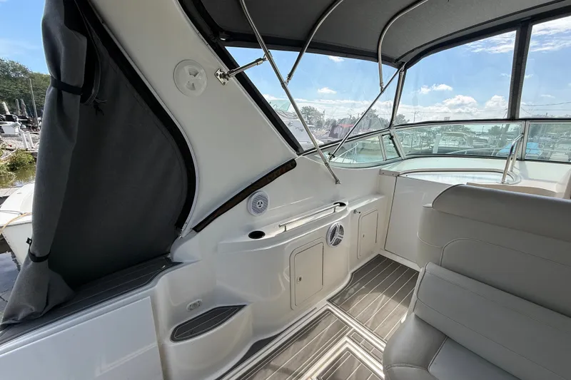 Slide: The Image of 1999 Cruisers Yachts 3075 Rogue interior with seating and helm, featuring sleek design elements. - 12