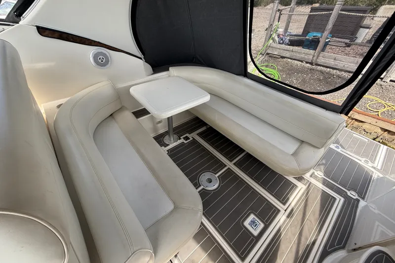 Slide: The Image of Interior of 1999 Cruisers Yachts 3075 Rogue with white seating and table. - 10