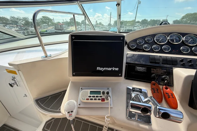 Slide: The Image of 1999 Cruisers Yachts 3075 Rogue helm with Raymarine display and control panel. - 21