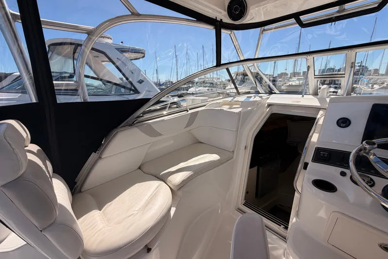 Slide: The Image of Interior view of a 2007 Boston Whaler 285 Conquest boat, featuring plush seating and helm. - 28