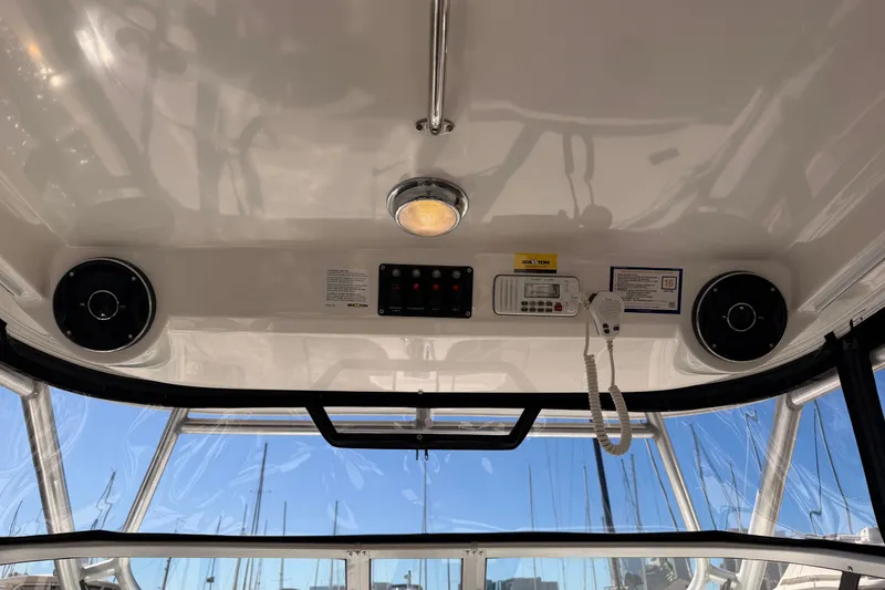 Slide: The Image of Interior view of a 2007 Boston Whaler 285 Conquest boat cockpit with speakers and controls. - 30