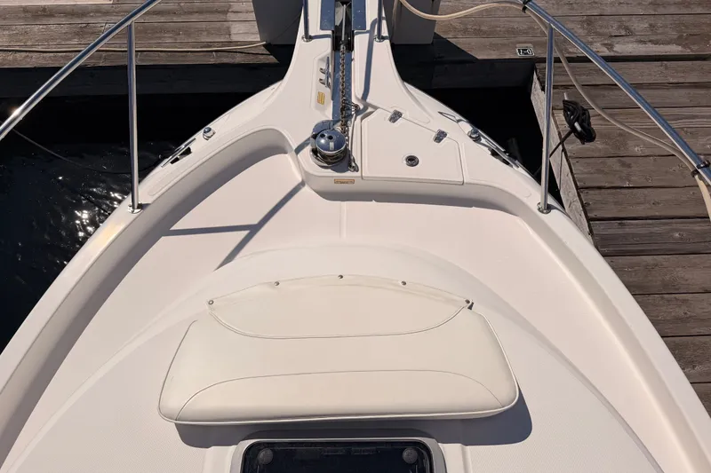 Slide: The Image of 2007 Boston Whaler 285 Conquest boat bow with anchor and seating, docked at marina. - 19