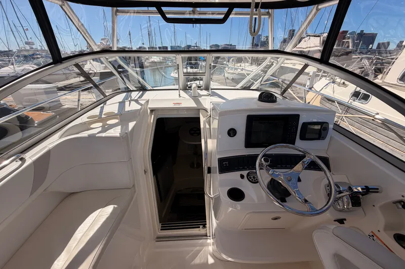 Slide: The Image of 2007 Boston Whaler 285 Conquest helm with steering wheel and navigation equipment. - 23