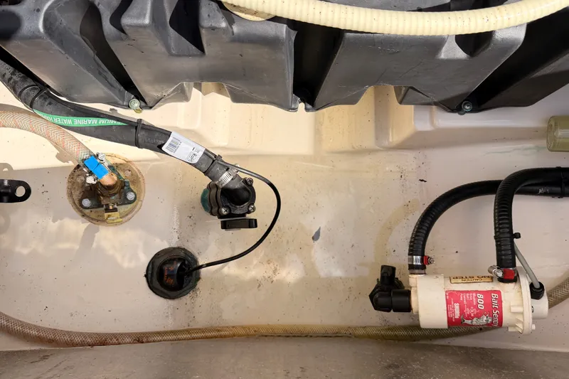 Slide: The Image of Boat engine compartment of a 2007 Boston Whaler 285 Conquest with visible hoses and components. - 50