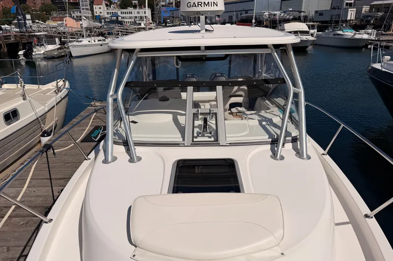 Slide: The Image of 2007 Boston Whaler 285 Conquest docked at marina, featuring Garmin equipment. - 17