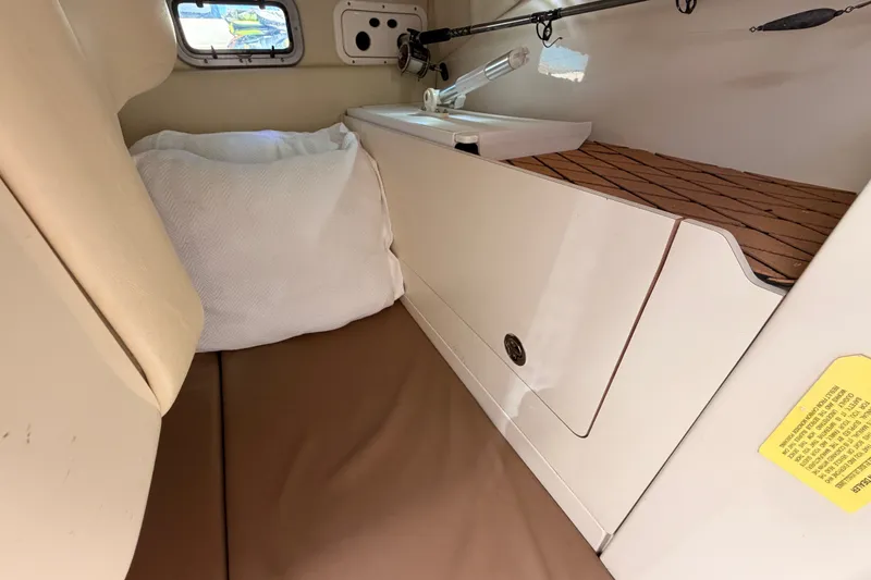 Slide: The Image of Interior cabin of 2007 Boston Whaler 285 Conquest with cushioned seating and storage. - 41