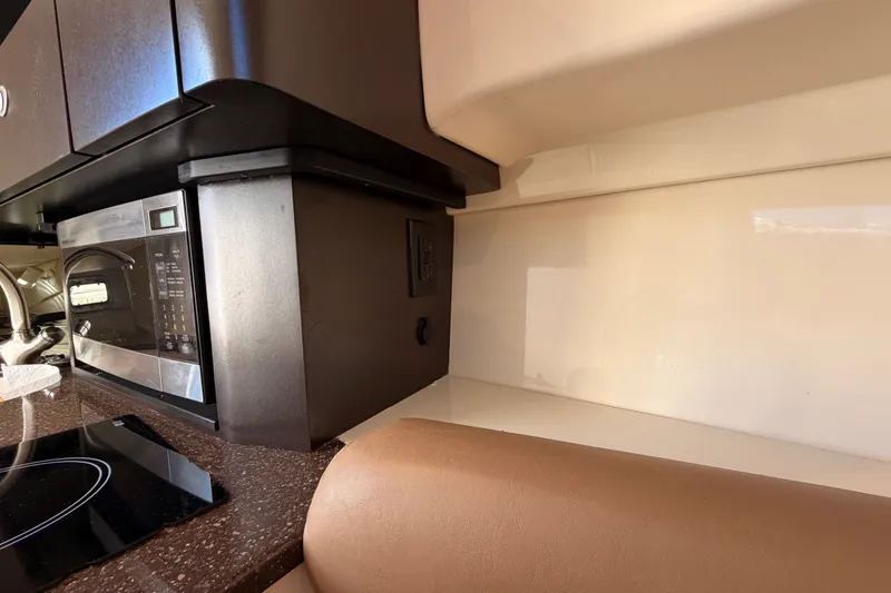 Slide: The Image of Interior of 2007 Boston Whaler 285 Conquest featuring a microwave and countertop. - 36