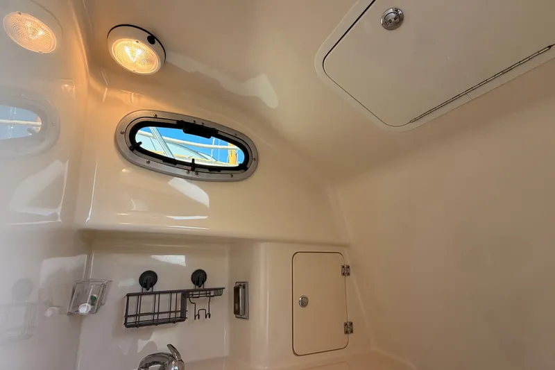 Slide: The Image of Interior cabin of 2007 Boston Whaler 285 Conquest with porthole and storage compartments. - 42