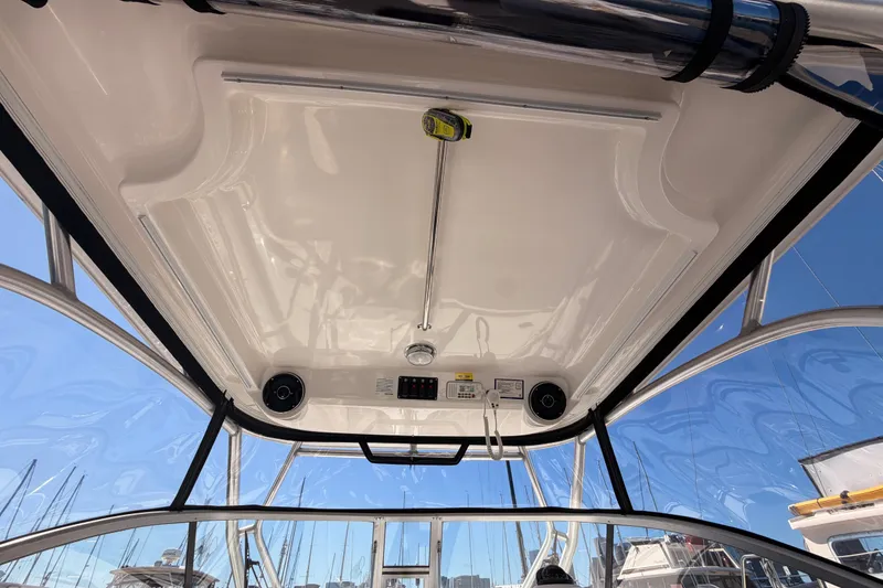 Slide: The Image of Interior view of 2007 Boston Whaler 285 Conquest boat's helm ceiling and controls. - 31