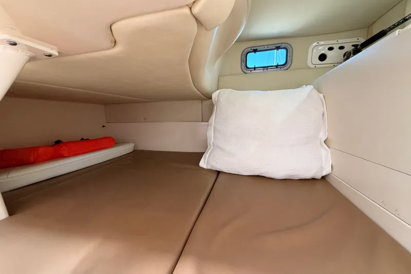 Slide: The Image of 2007 Boston Whaler 285 Conquest cabin interior with bed and small window. - 40