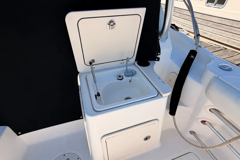 Slide: The Image of Boston Whaler 285 Conquest 2007 boat sink with closed storage compartment. - 15
