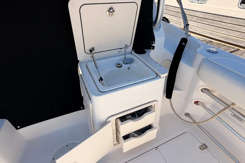 Slide: The Image of Boston Whaler 285 Conquest 2007 boat interior with sink and storage compartments. - 16