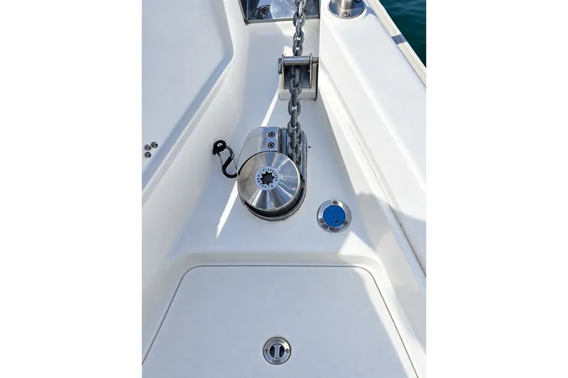 Slide: The Image of Anchor windlass on 1996 Hunter 376 sailboat deck, featuring chain and control panel. - 3