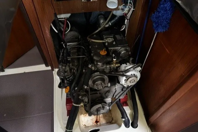 Slide: The Image of Engine compartment of a 1996 Hunter 376 sailboat, showcasing mechanical components and wiring. - 4