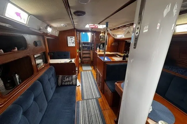 Slide: The Image of Interior of a 1973 C&C 48 sailboat with cozy seating and wooden finishes. - 16