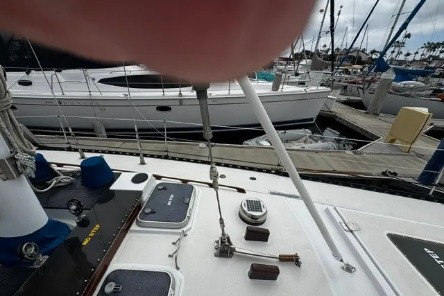 Slide: The Image of Deck view of a 1973 C&C 48 sailboat docked at a marina. - 36