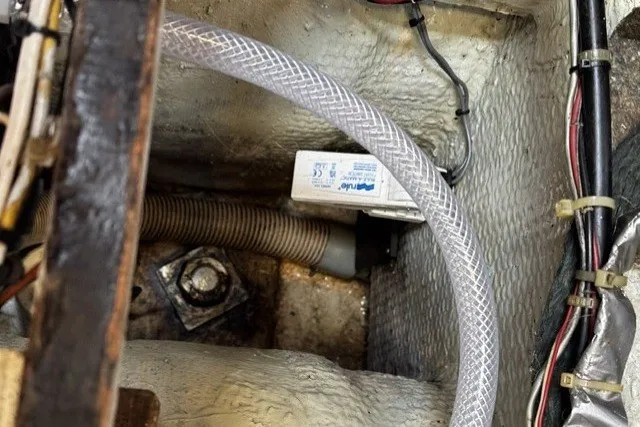 Slide: The Image of Engine compartment of a 1973 C&C 46 sailboat, showing hoses and wiring. - 47