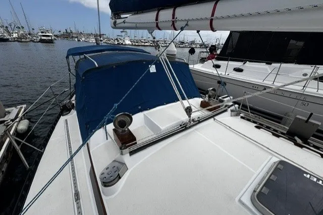 Slide: The Image of Sailboat docked in marina, C&C 48 model, 1973, with blue canopy and visible rigging. - 33