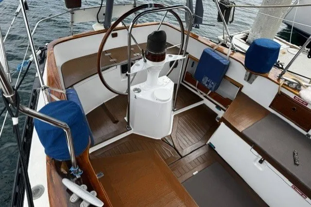 Slide: The Image of Cockpit of a 1973 C&C 48 sailboat with wooden accents and steering wheel. - 32