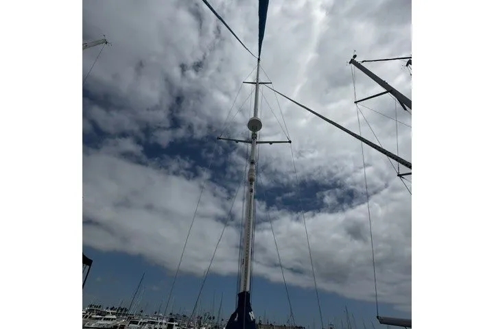 Slide: The Image of Tall mast of a 1973 C&C 48 sailboat against a cloudy sky. - 41