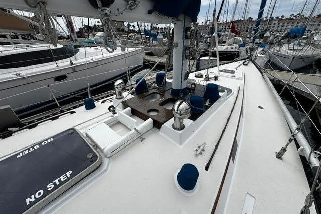 Slide: The Image of 1973 C&C 48 sailboat deck with rigging, docked in a marina. - 34