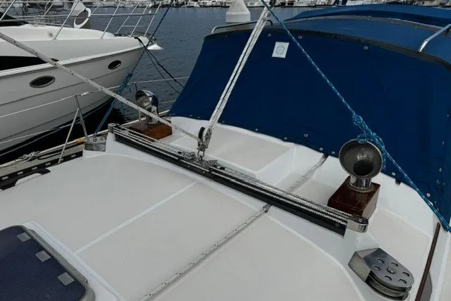 Slide: The Image of Deck view of a 1973 C&C 48 sailboat with blue canvas cover. - 43