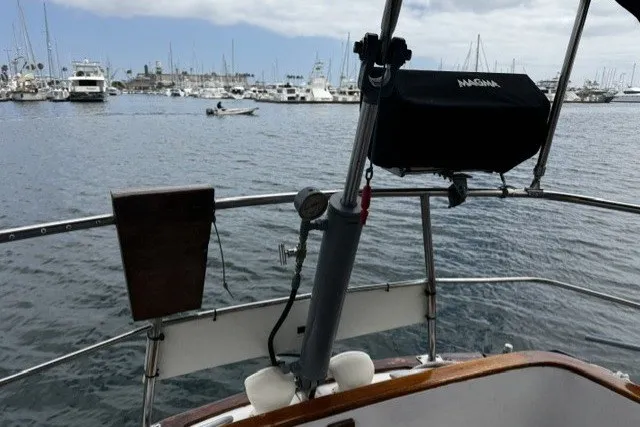 Slide: The Image of Cockpit view of a 1973 C&C 48 sailboat in a marina setting. - 28