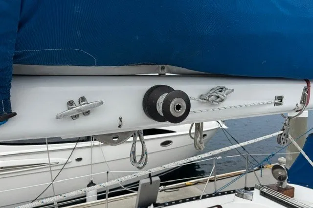 Slide: The Image of Sailboat rigging on a 1973 C&C 48, featuring ropes and pulleys at a marina. - 42