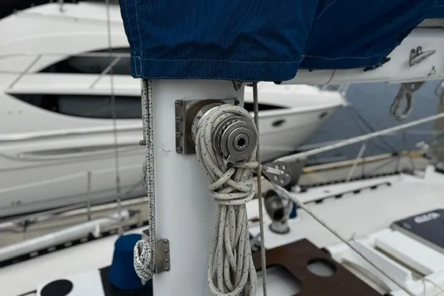 Slide: The Image of Sailboat mast with coiled rope, C&C 48 model, 1973, docked near another yacht. - 37
