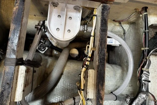 Slide: The Image of Engine compartment of a 1973 C&C 46 sailboat, showing hoses and wiring. - 49