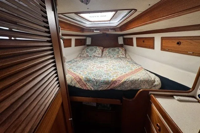 Slide: The Image of Cozy cabin interior of a 1973 C&C 48 sailboat with a comfortable bed and wooden accents. - 18